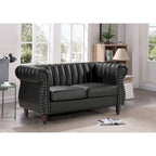 Divanetto Capri in similpelle con braccioli arrotolati Chesterfield