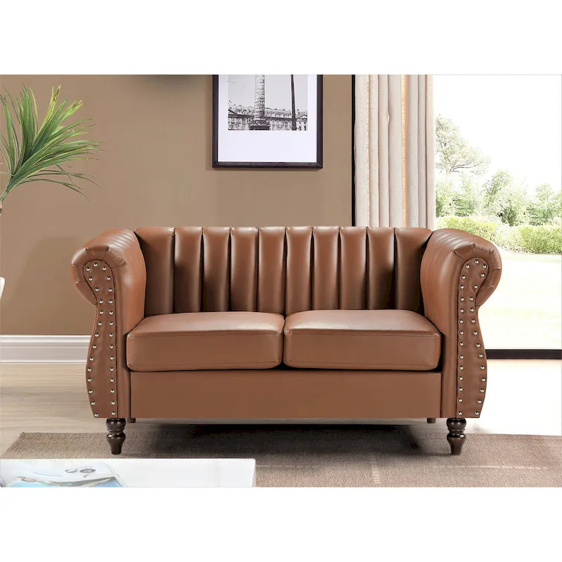 Divanetto Capri in similpelle con braccioli arrotolati Chesterfield