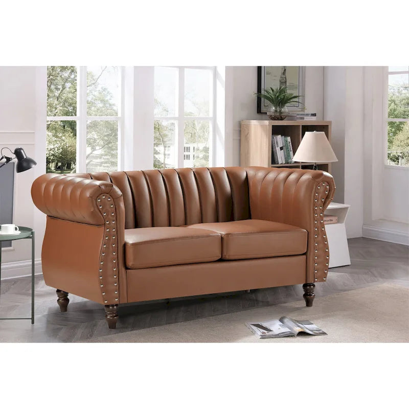 Divanetto Capri in similpelle con braccioli arrotolati Chesterfield