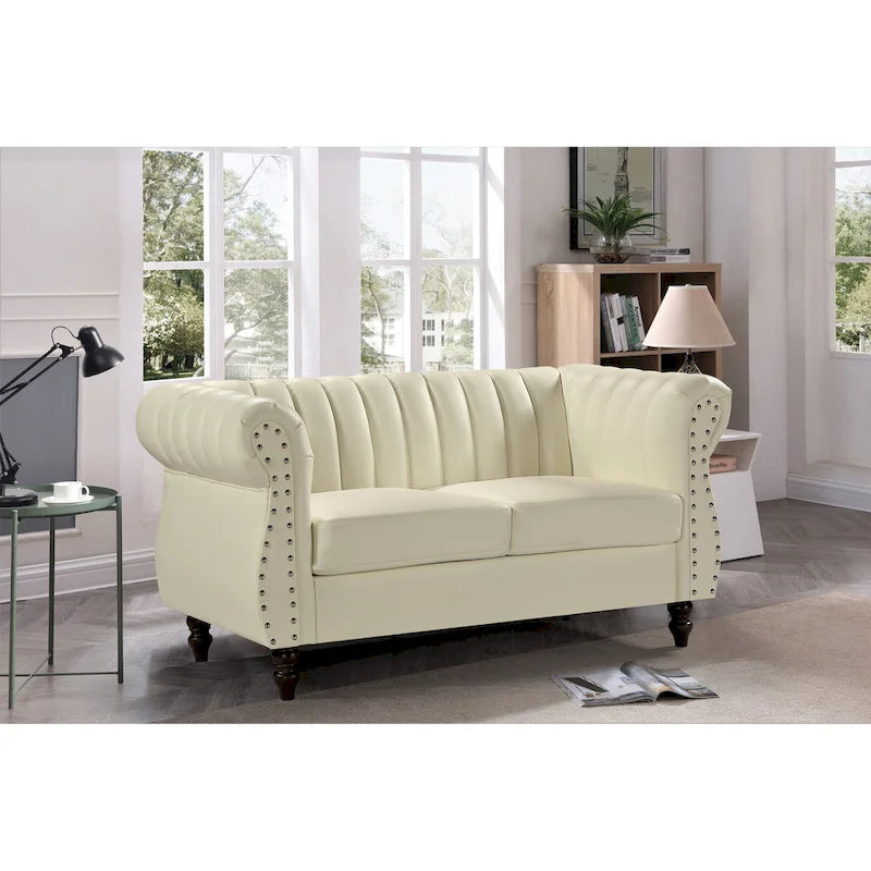 Divanetto Capri in similpelle con braccioli arrotolati Chesterfield